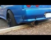 Skyline R32 driver rips exhaust off on gutter