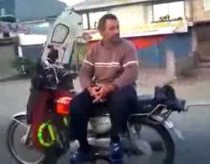 No hands, sideways fool on motorcycle