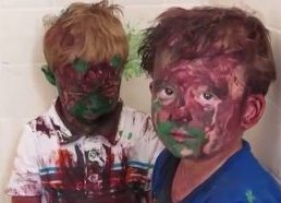 Kids play with paint a get it all over their faces
